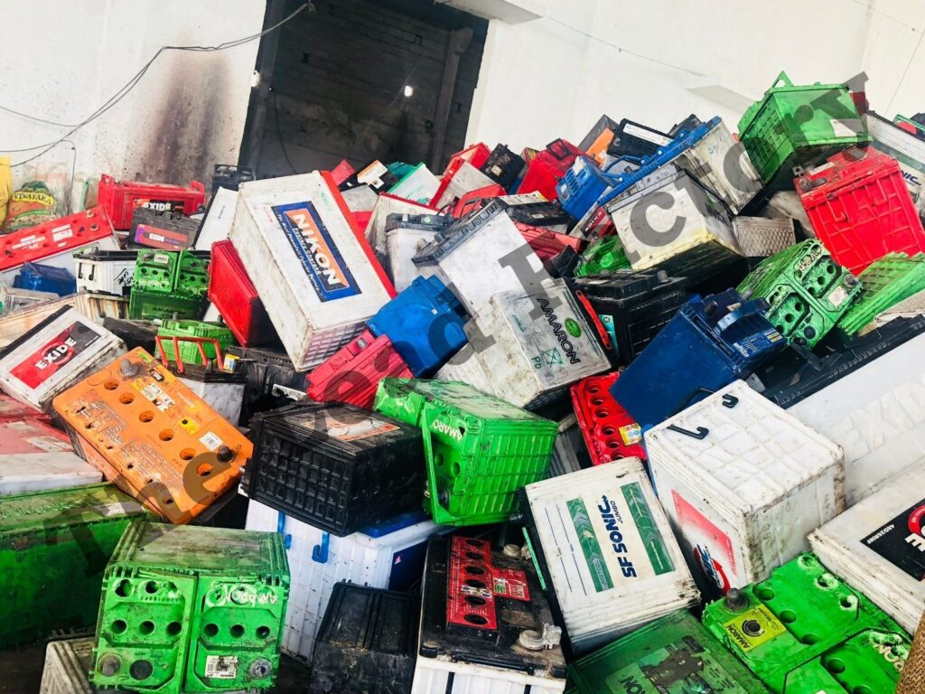 UPS and battery scrap in Hyderabad 5 A large pile of scrap car and inverter batteries for recycling, featuring brands like Exide and Amaron
